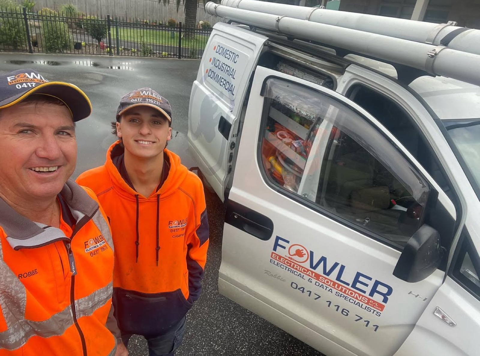 Robbie Fowler and an apprentice beside the Fowler Electrical Solutions van